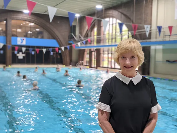 Jeanne Amyette, Aquatics Director at the Two Rivers YMCA standing in front of the large indoor pool